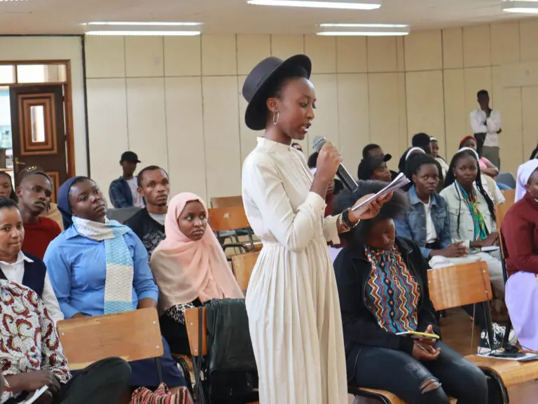 Facilitator coaching a room of young people